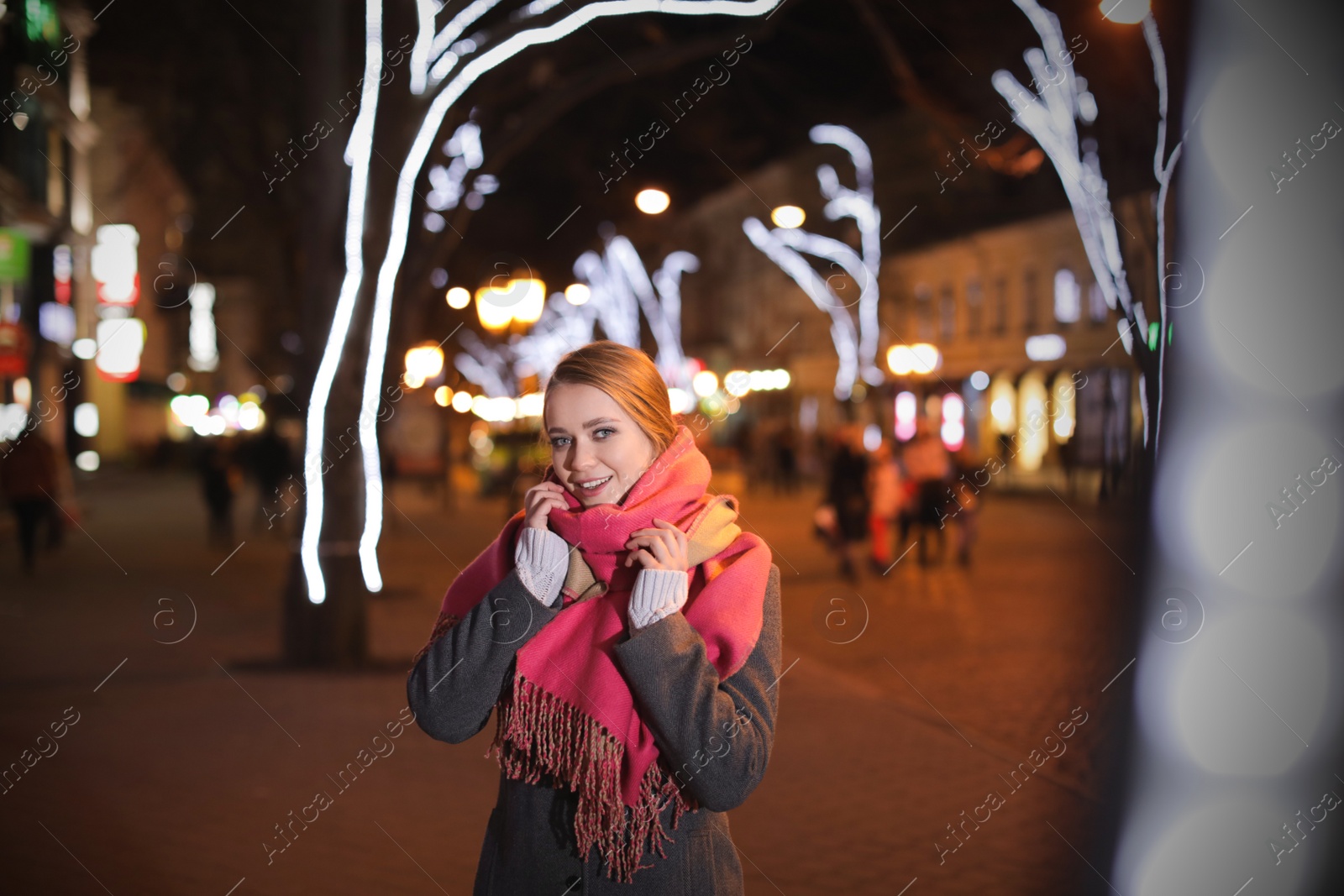 Photo of Beautiful young woman spending time in city at night