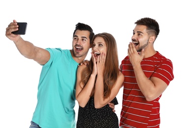Photo of Happy young people taking selfie on white background