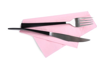Photo of Pink napkin with fork and knife on white background, top view