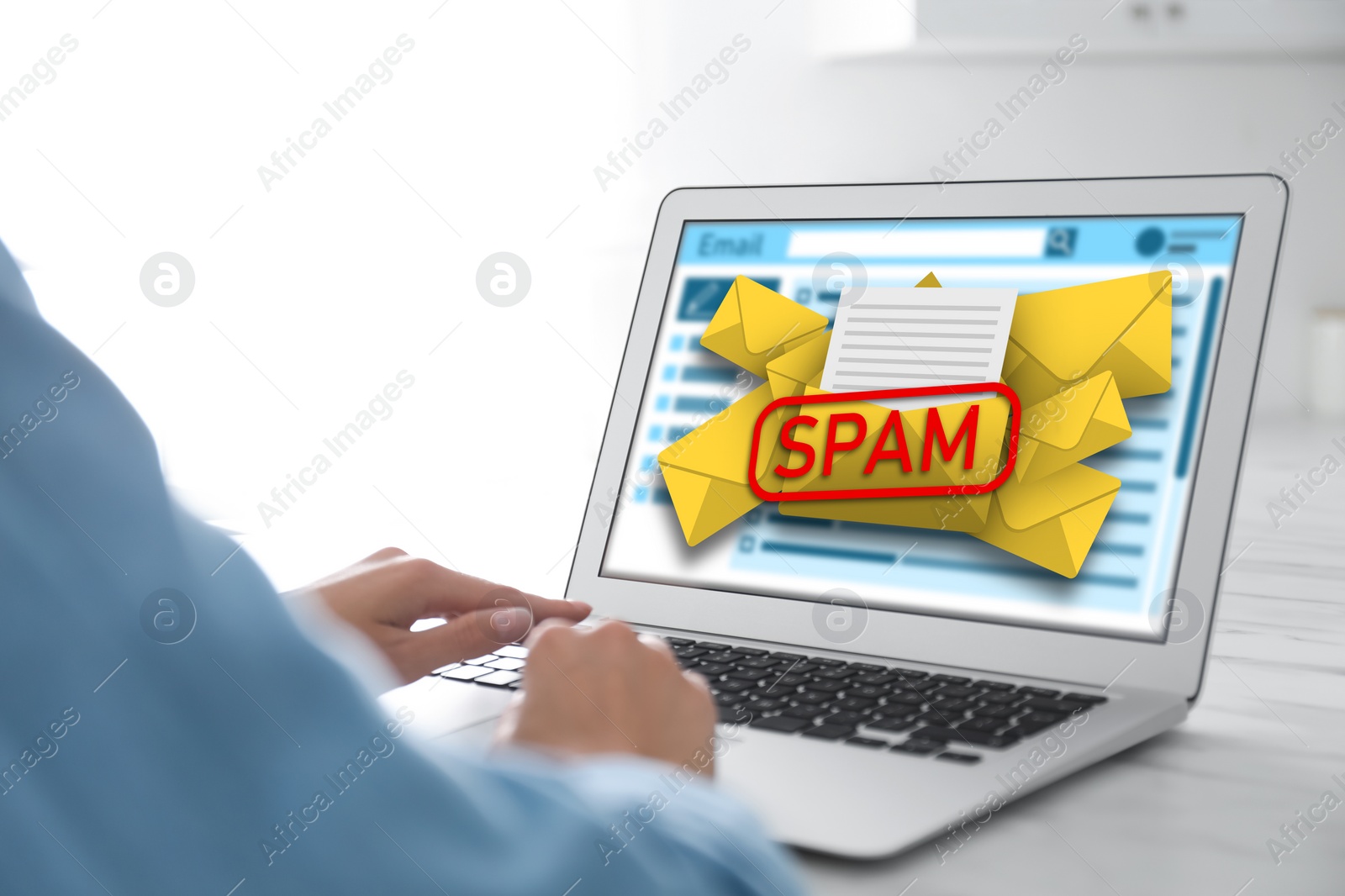 Image of Spam warning message. Woman using email software on laptop at office desk, closeup