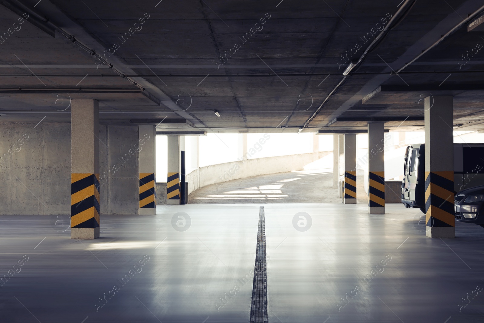 Photo of Open car parking garage with ramp on sunny day