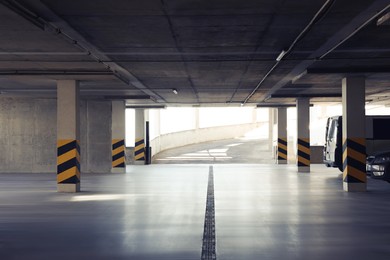Photo of Open car parking garage with ramp on sunny day