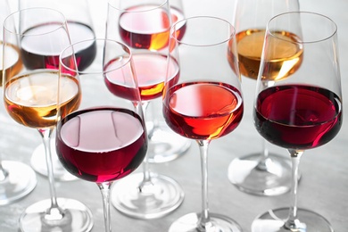 Group of glasses with different wines on light table