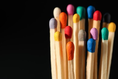 Photo of Matches with colorful heads on black background, closeup. Space for text