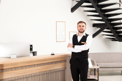 Portrait of receptionist near desk in modern hotel