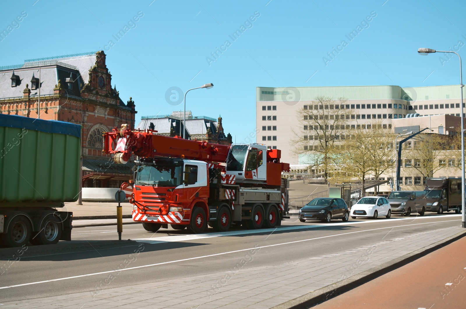 Photo of Beautiful view of city street traffic with modern cars and heavy duty truck on sunny day