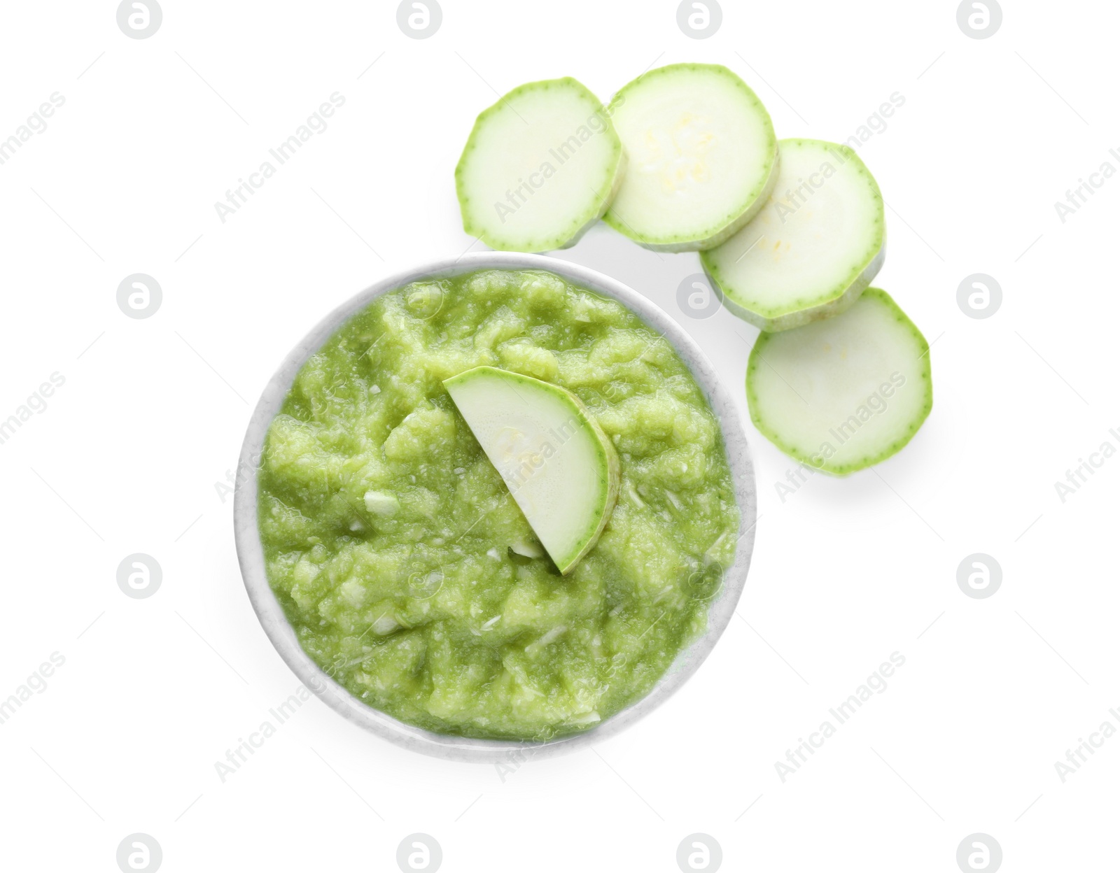 Photo of Delicious vegetable puree and zucchini slices on white background, top view. Healthy food