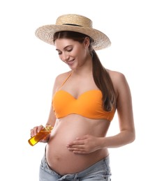 Young pregnant woman with sun protection oil on white background