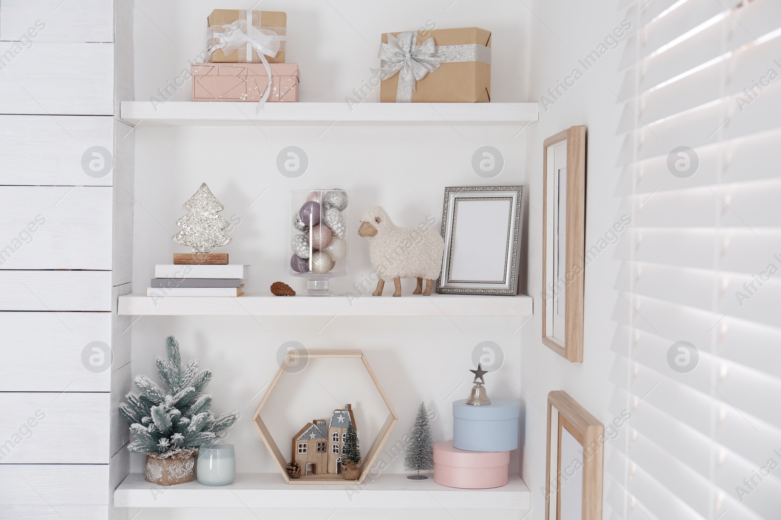 Photo of Wall shelves with beautiful Christmas decor indoors. Interior design