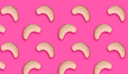 Image of Many tasty cashew nuts on pink background, flat lay. Banner design