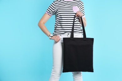 Woman with eco bag on color background. Mock up for design