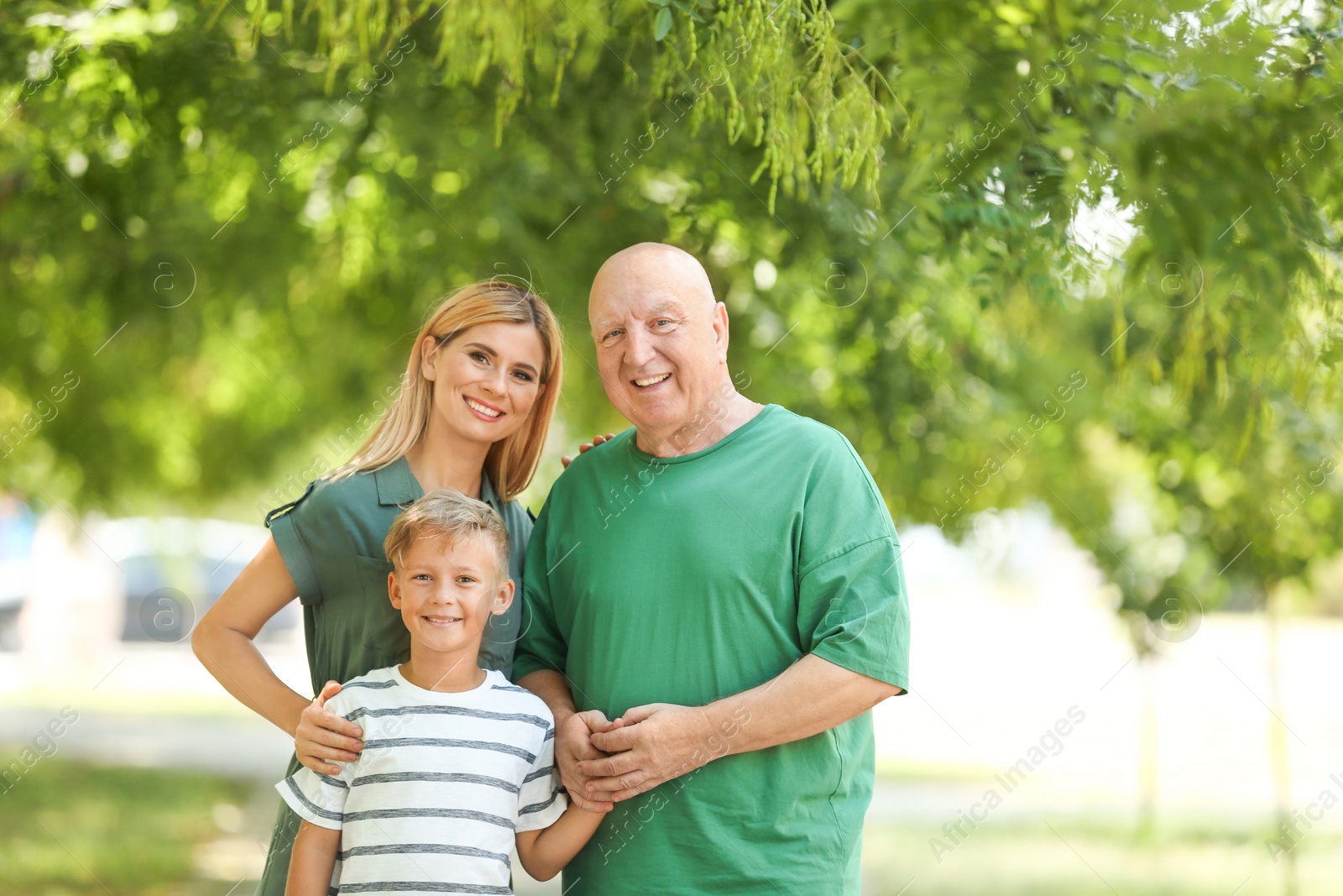Photo of Woman with son and elderly father in park