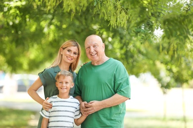 Woman with son and elderly father in park