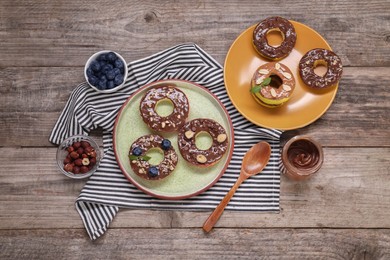 Photo of Fresh apples with nut butters, blueberries, chocolate chips and nuts on wooden table, flat lay