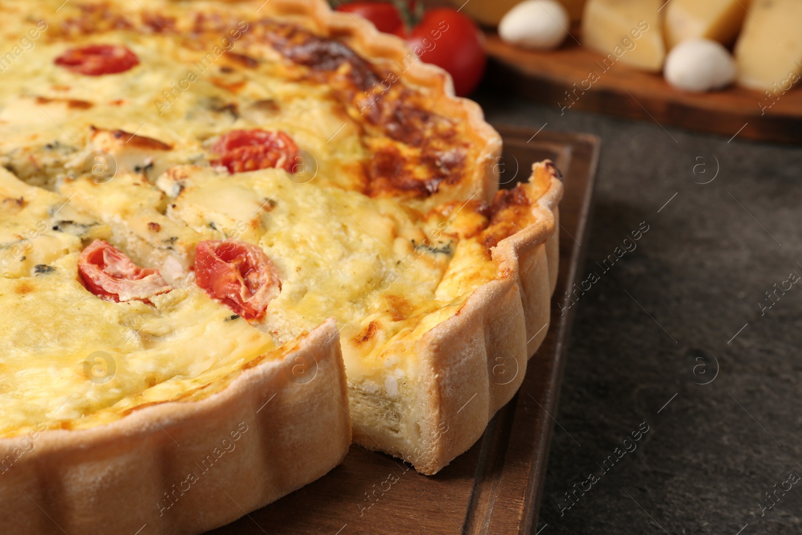 Photo of Delicious homemade cheese quiche on gray table, closeup