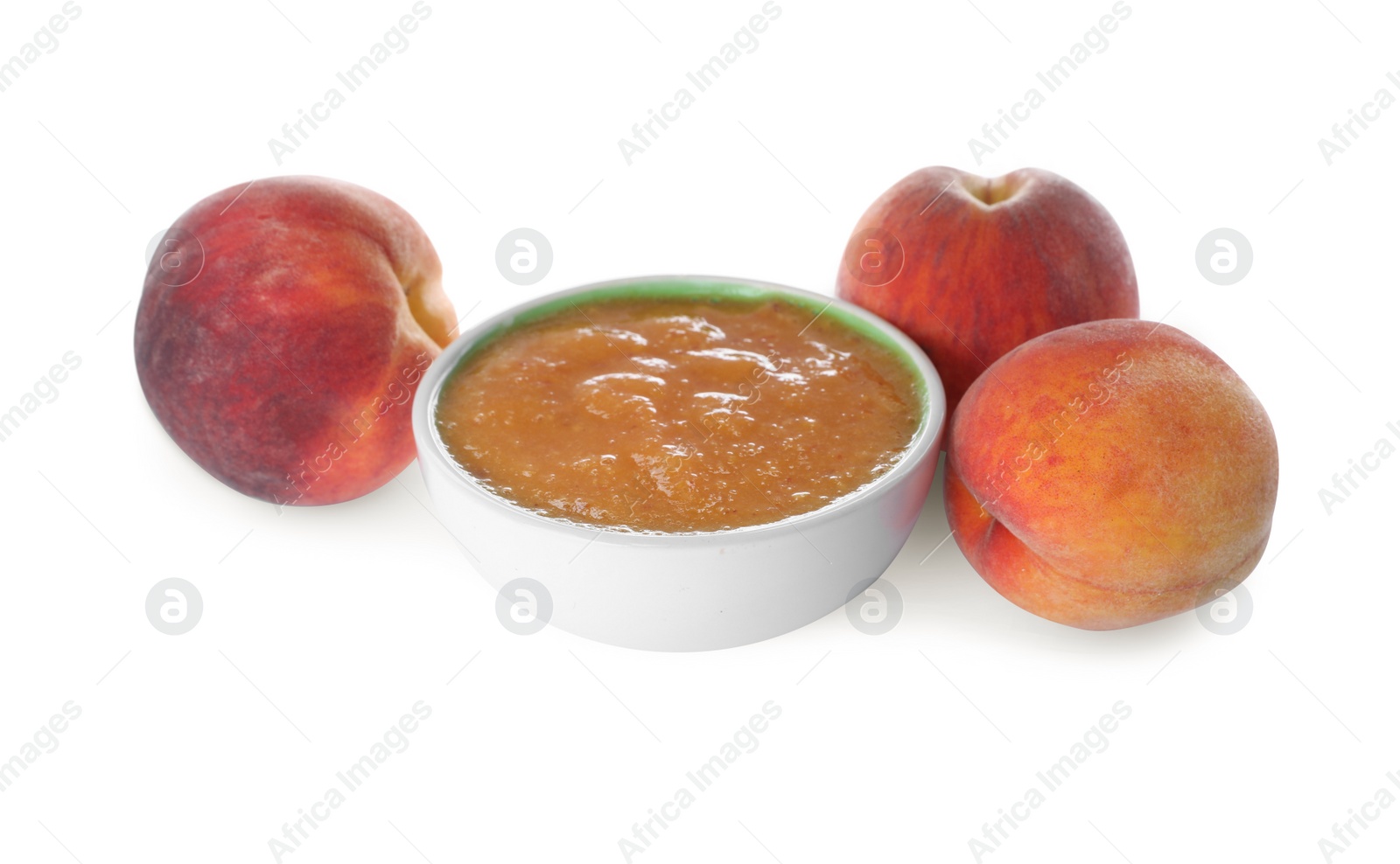 Photo of Peach puree in bowl and fresh fruits on white background