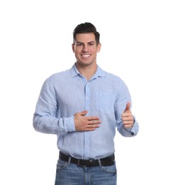 Photo of Happy healthy man touching his belly on white background