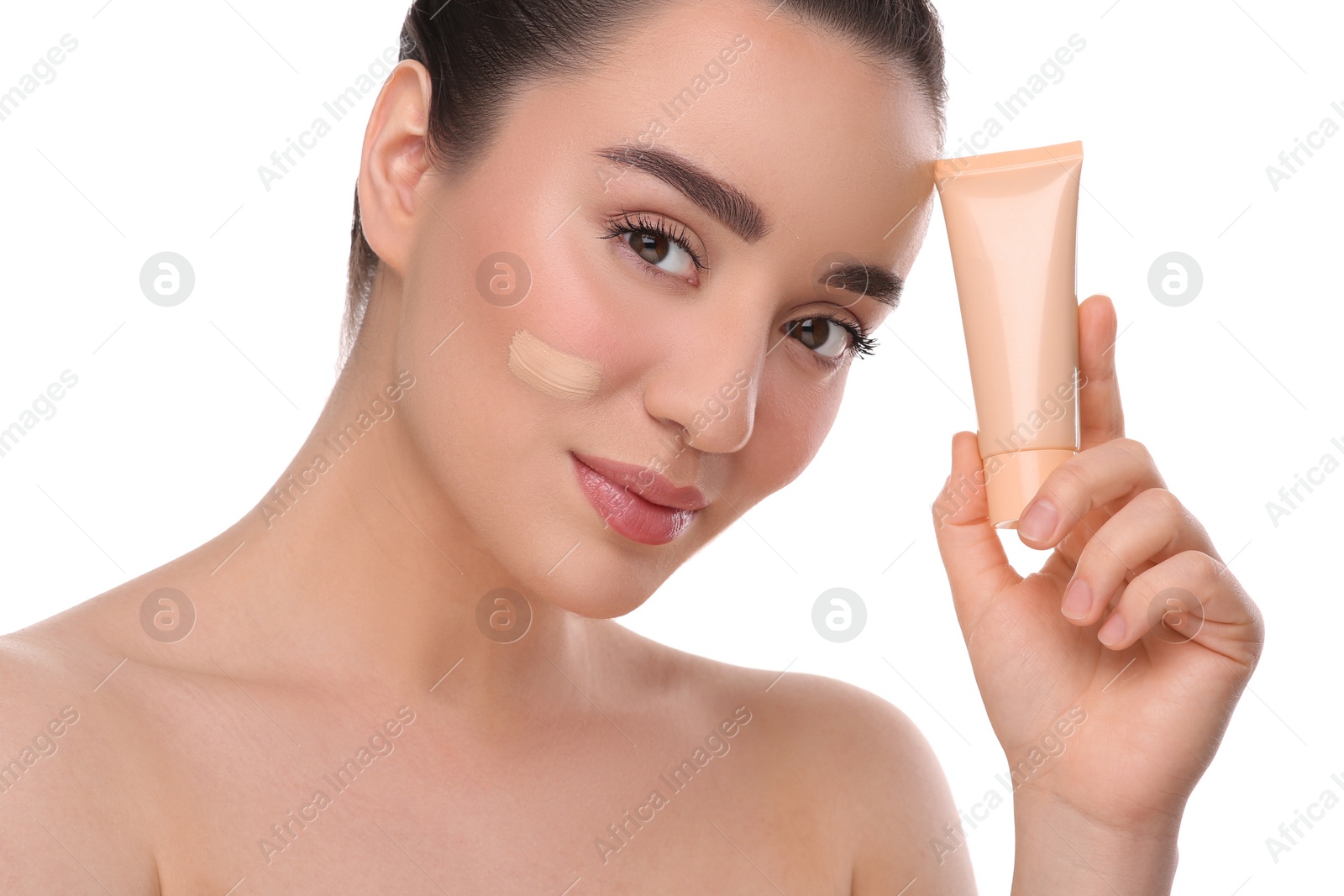 Photo of Woman holding tube of foundation on white background