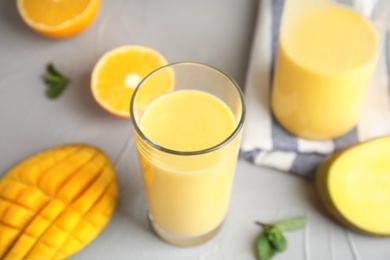 Fresh mango drink and tropical fruits on table