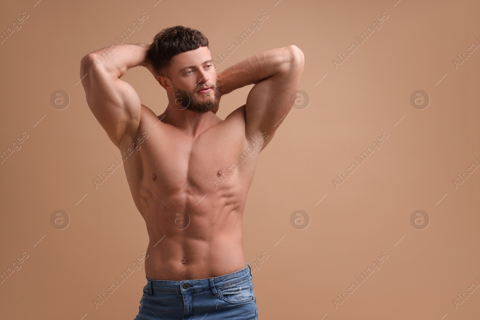 Photo of Handsome muscular man on beige background, space for text. Sexy body