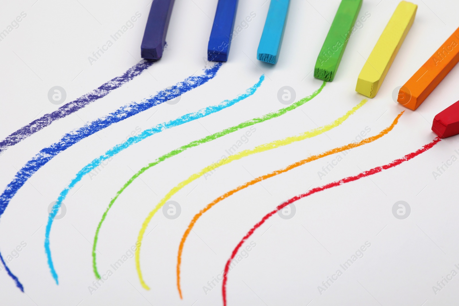 Photo of Colorful pastel chalks and lines on white background. Drawing materials