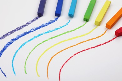 Colorful pastel chalks and lines on white background. Drawing materials