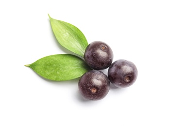 Fresh acai berries with leaves on white background