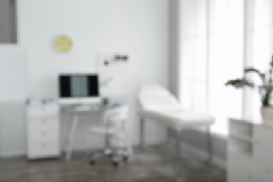 Photo of Blurred view of modern medical office. Doctor's workplace