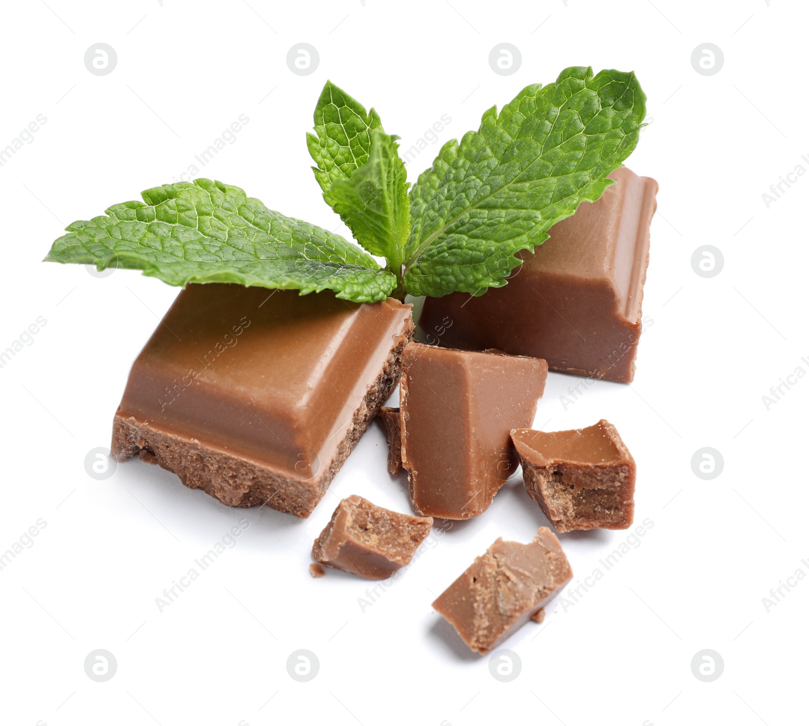 Photo of Pieces of milk chocolate with mint on white background