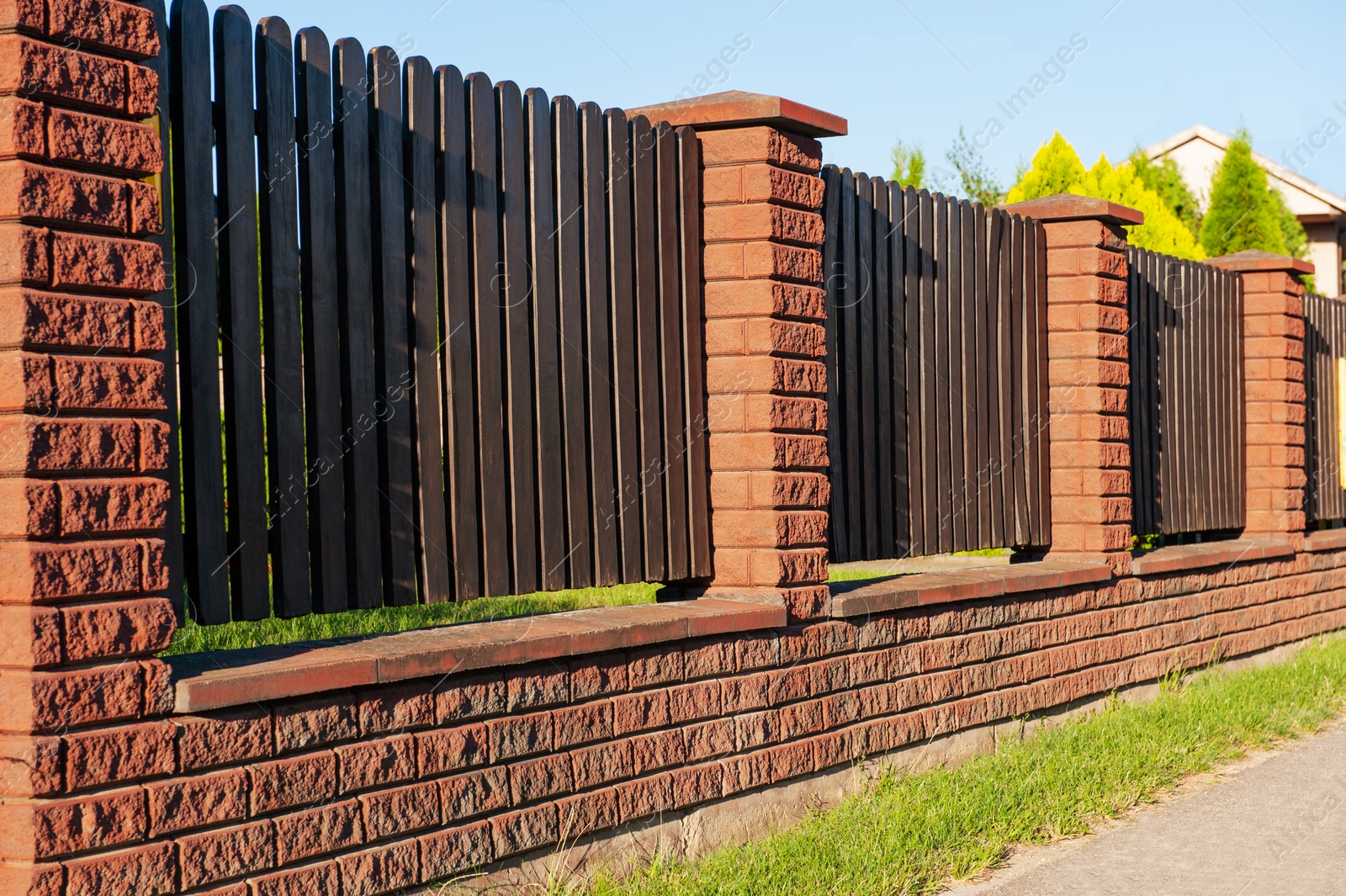 Photo of Beautiful wooden fence on sunny day outdoors