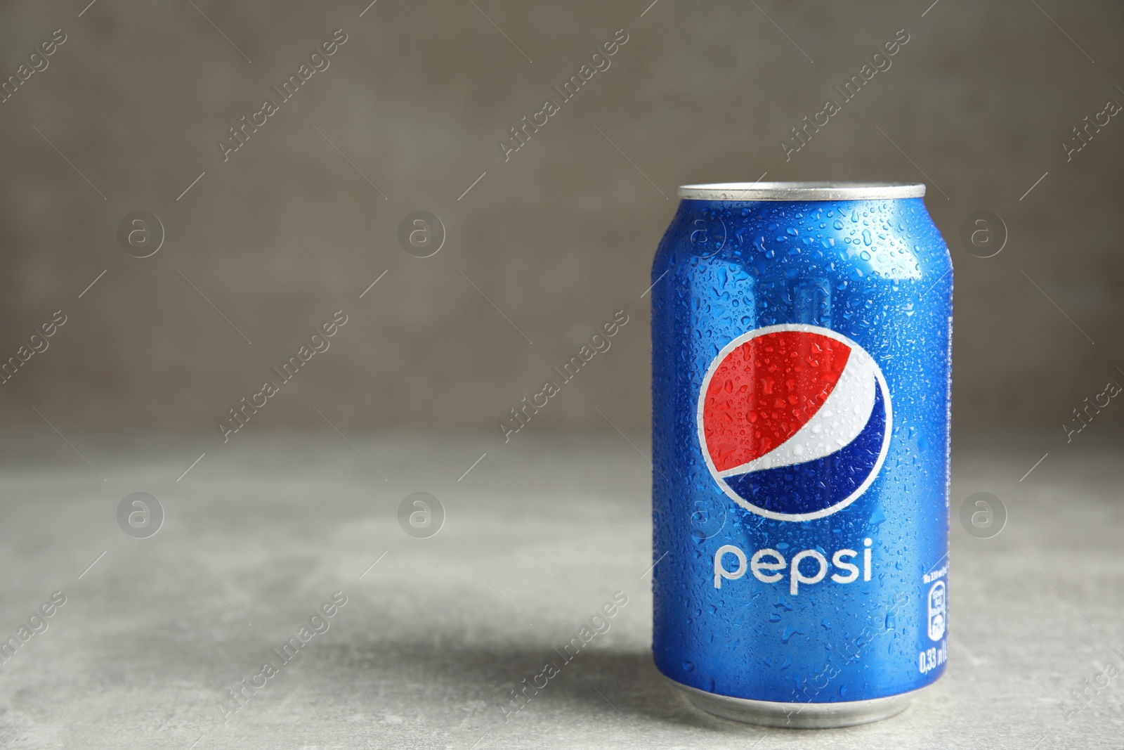 Photo of MYKOLAIV, UKRAINE - FEBRUARY 9, 2021: Can of Pepsi on grey table, space for text