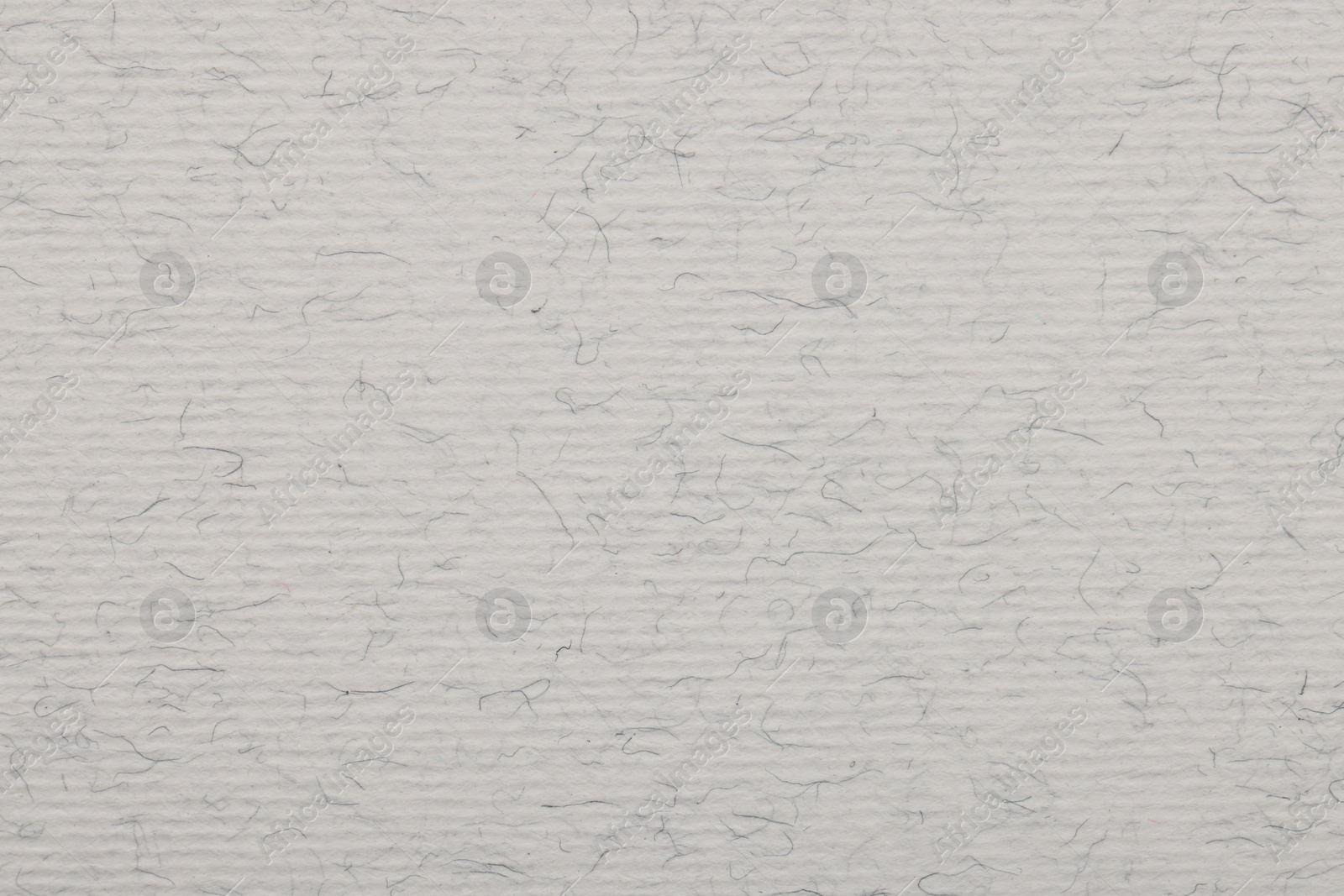 Photo of Texture of light grey paper sheet as background, top view