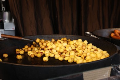 Photo of Delicious roasted potatoes in frying pan indoors