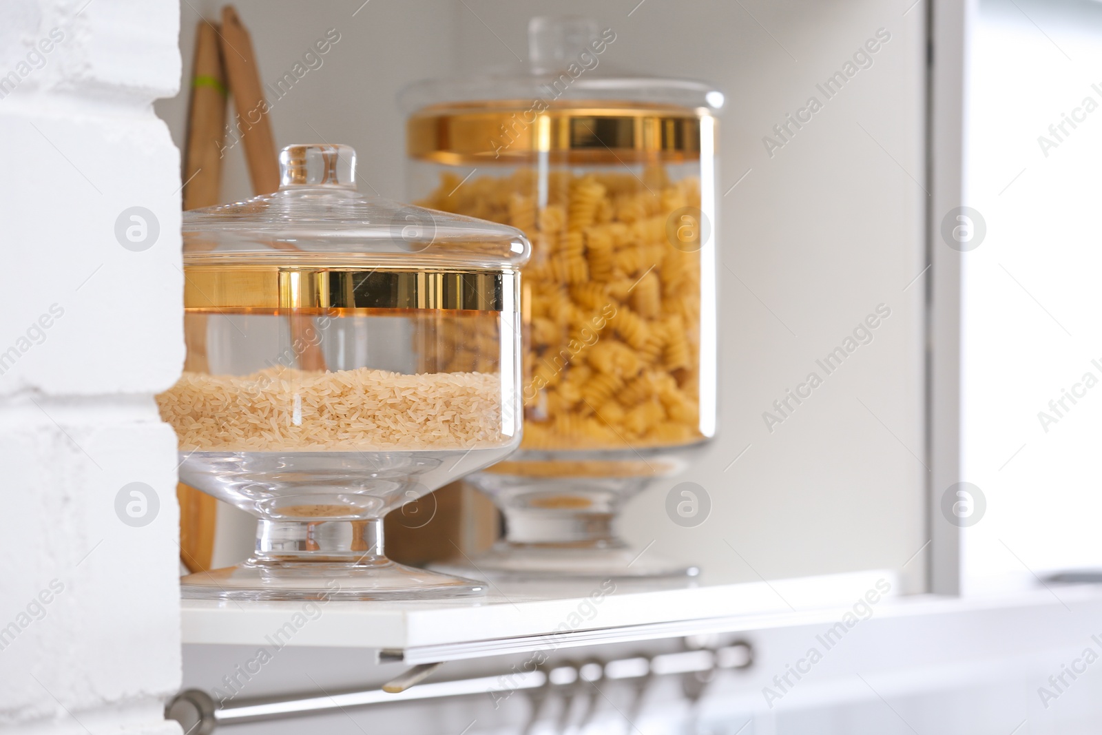 Photo of Shelf with raw foodstuff in modern kitchen