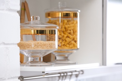 Photo of Shelf with raw foodstuff in modern kitchen