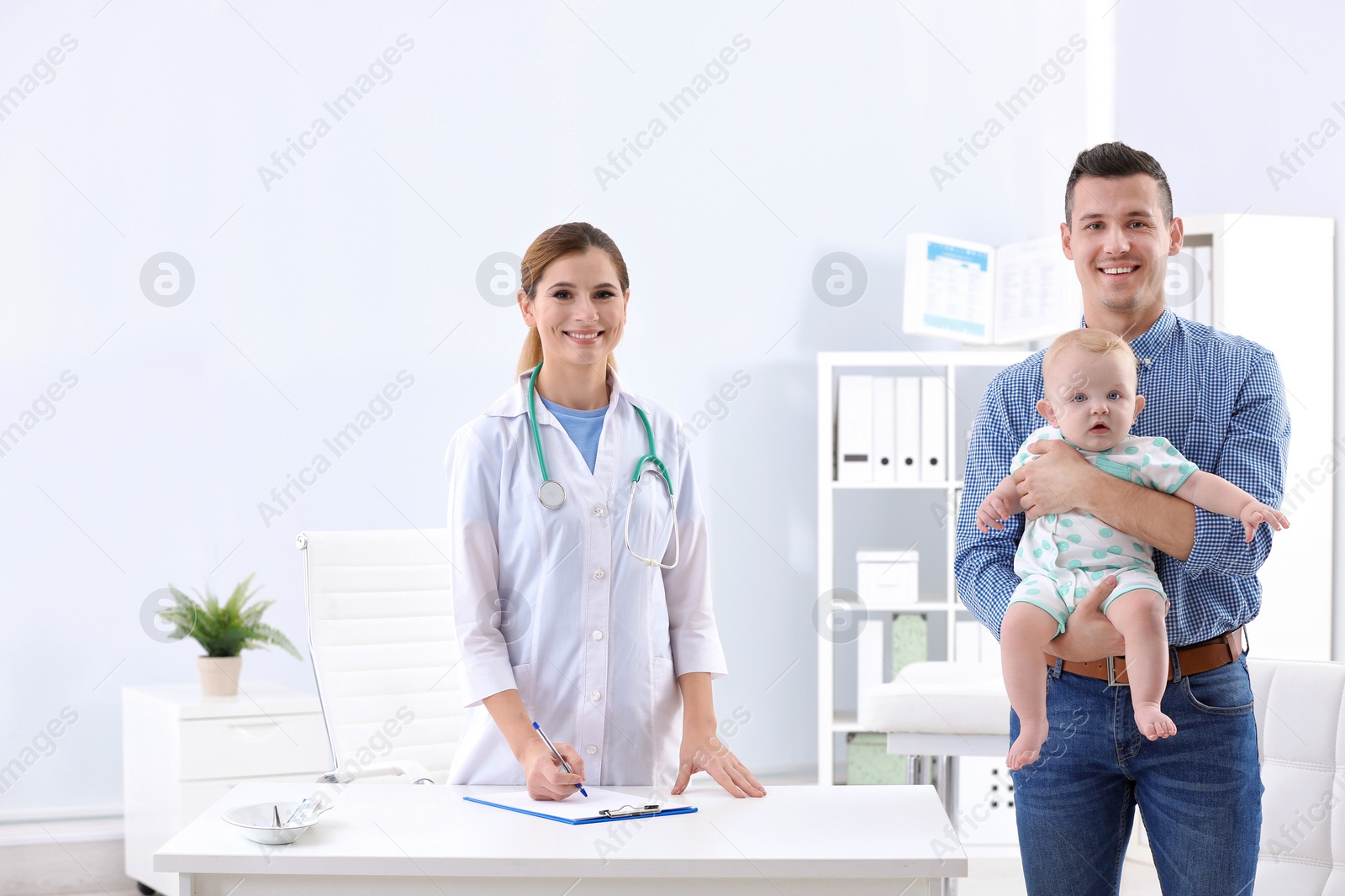 Photo of Man with his baby visiting children's doctor in hospital