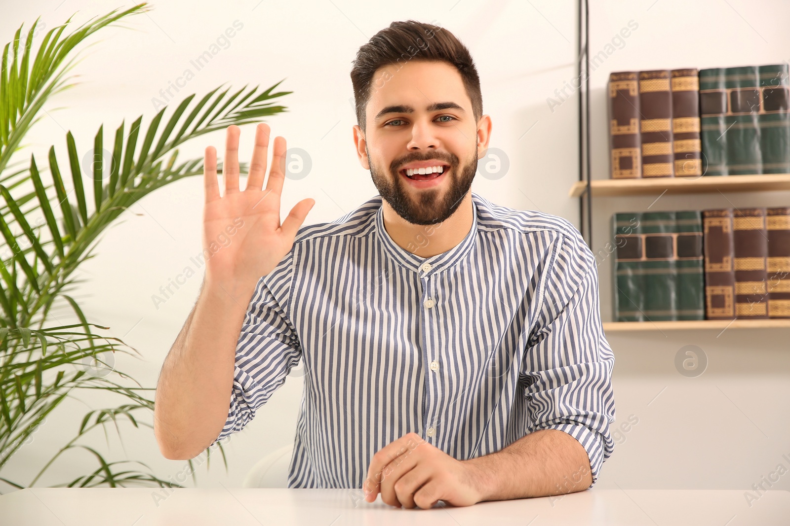 Photo of Young man using video chat at home, view from web camera