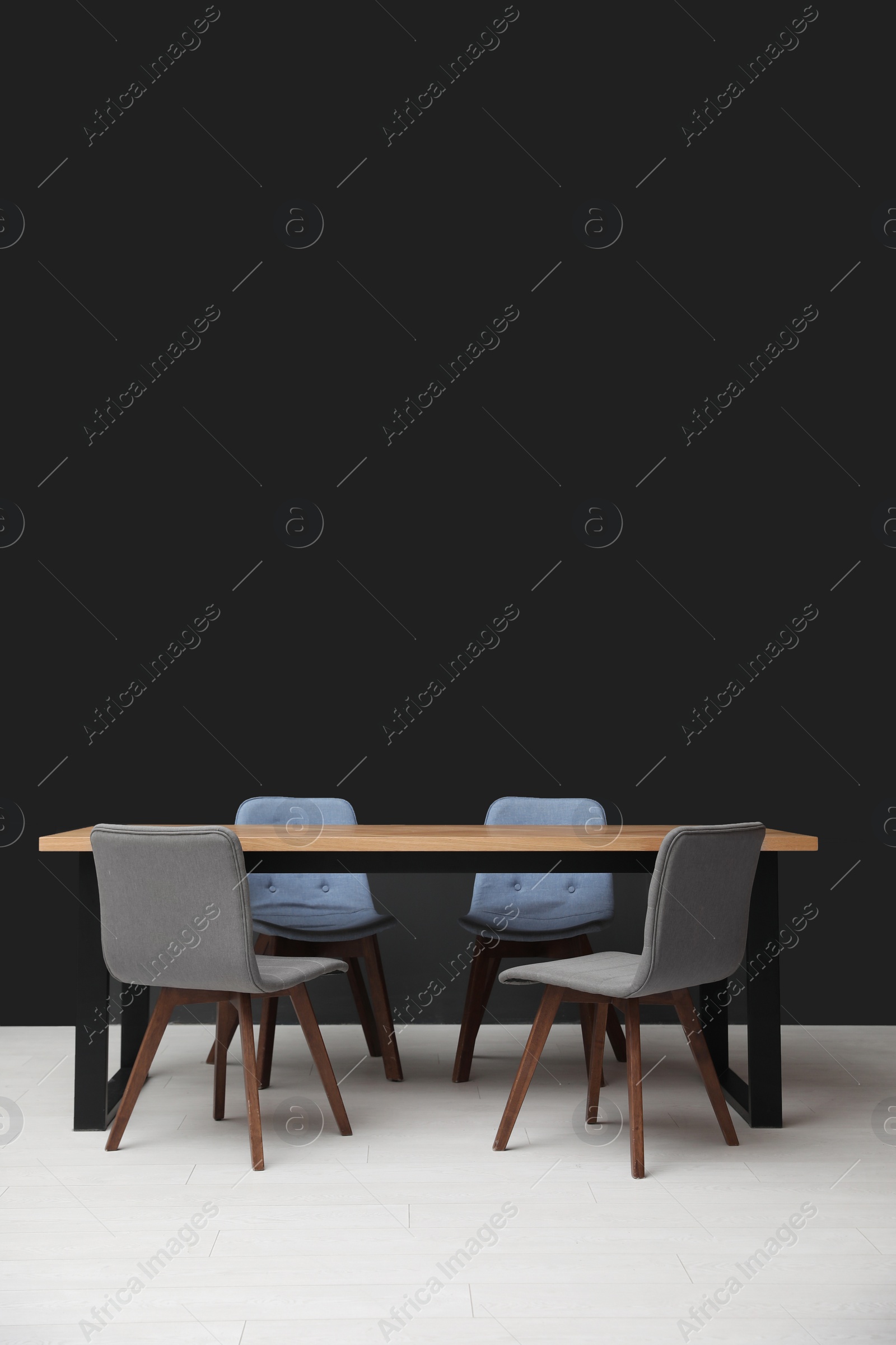 Photo of Modern empty wooden table near black wall