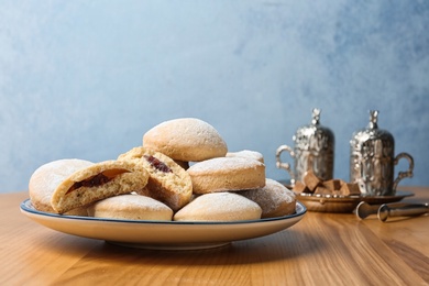 Plate of traditional cookies for Islamic holidays on table, space for text. Eid Mubarak