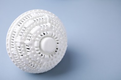 Photo of Laundry dryer ball on light grey background, space for text