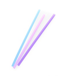 Photo of Color plastic cocktail tubes on white background, top view