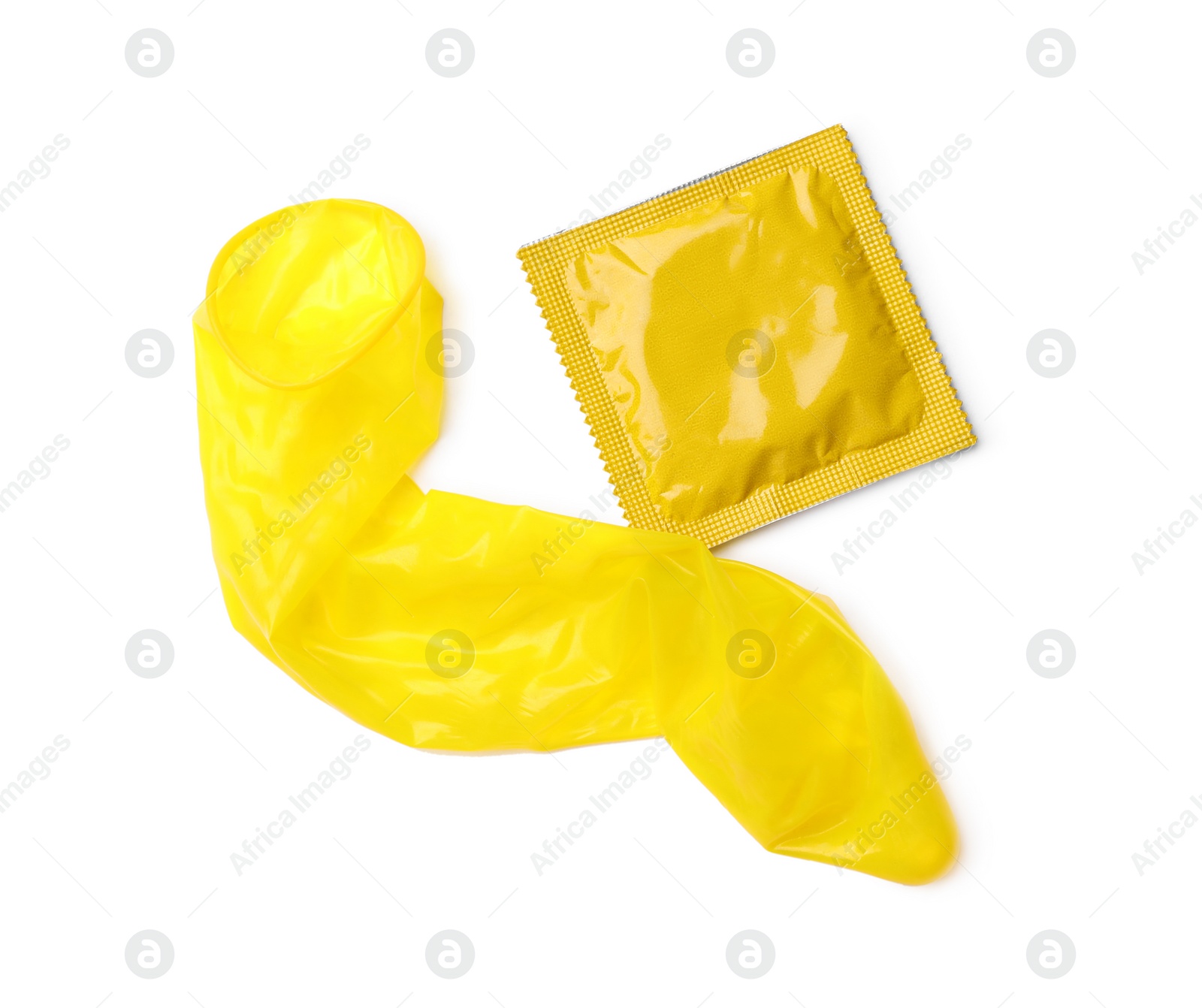 Photo of Yellow condoms on white background, top view. Safe sex concept