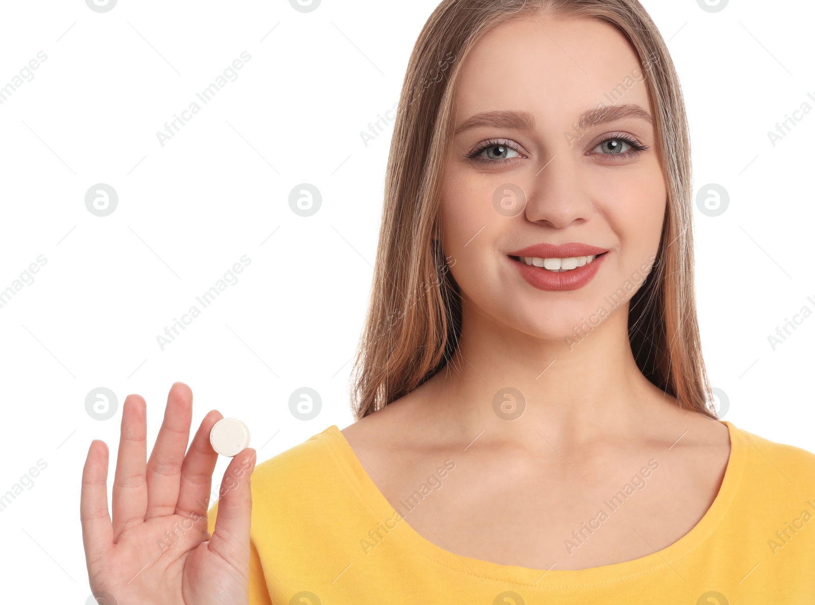 Photo of Young woman with vitamin pill on white background