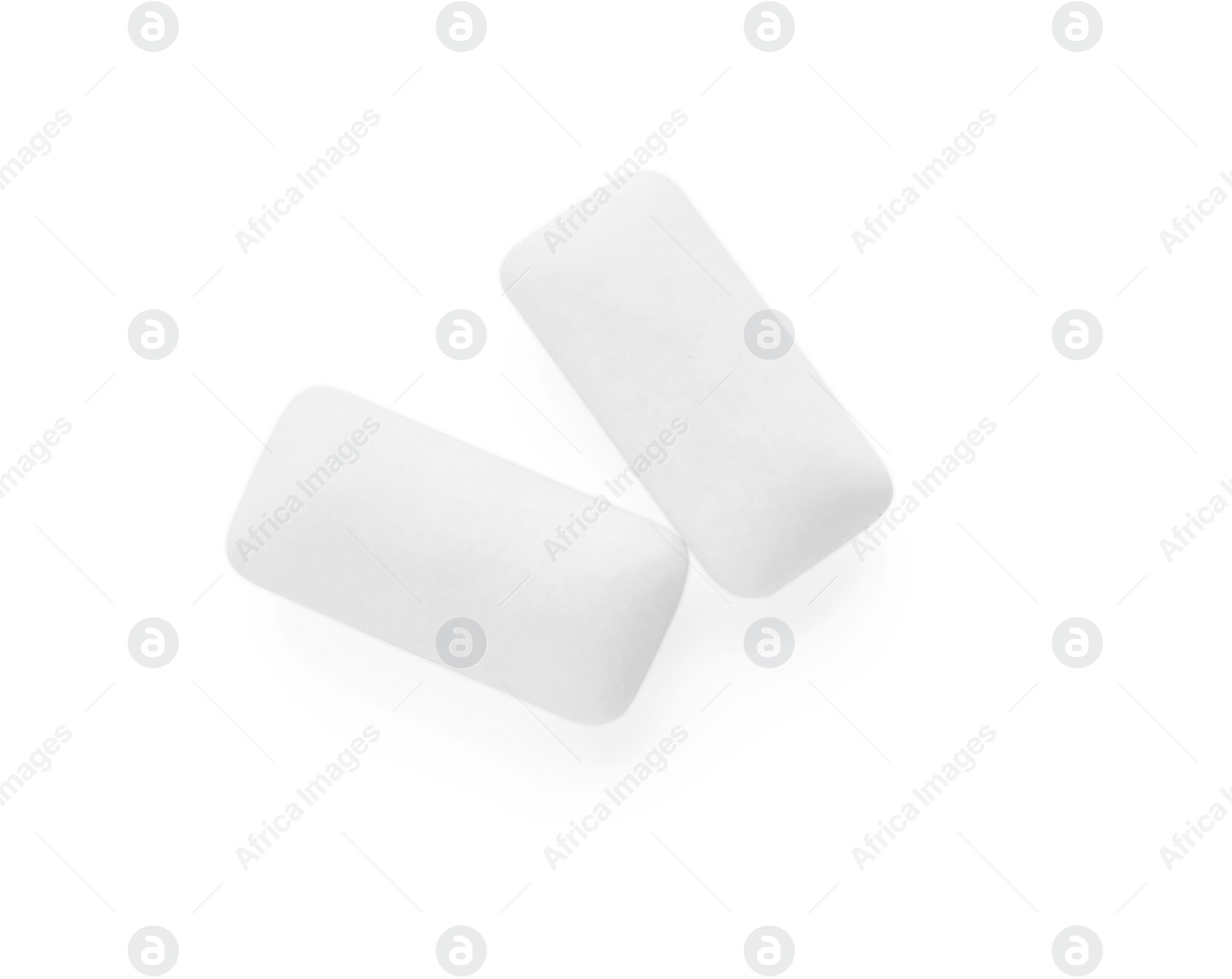 Photo of Two pieces of chewing gum on white background, top view