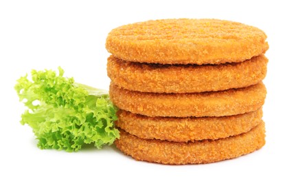 Uncooked breaded cutlets, tomato and lettuce on white background. Freshly frozen semi-finished product