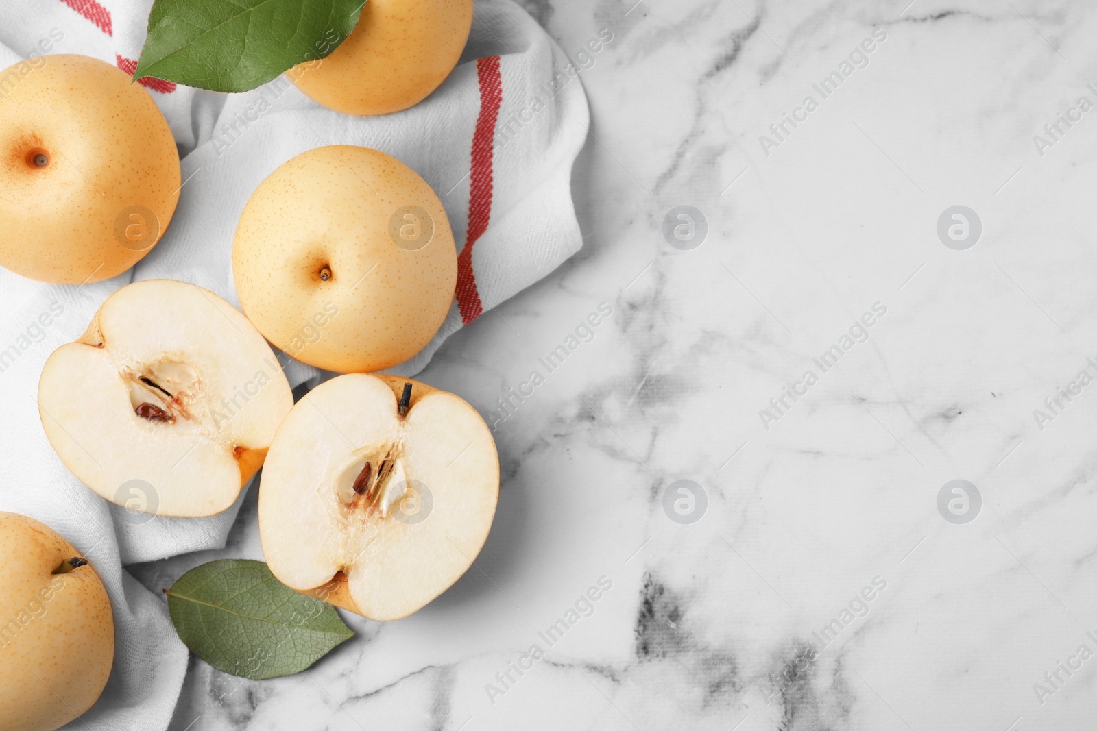 Photo of Delicious apple pears on white marble table, flat lay. Space for text