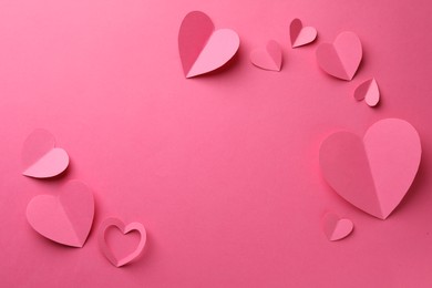 Photo of Paper hearts on pink background, flat lay. Space for text