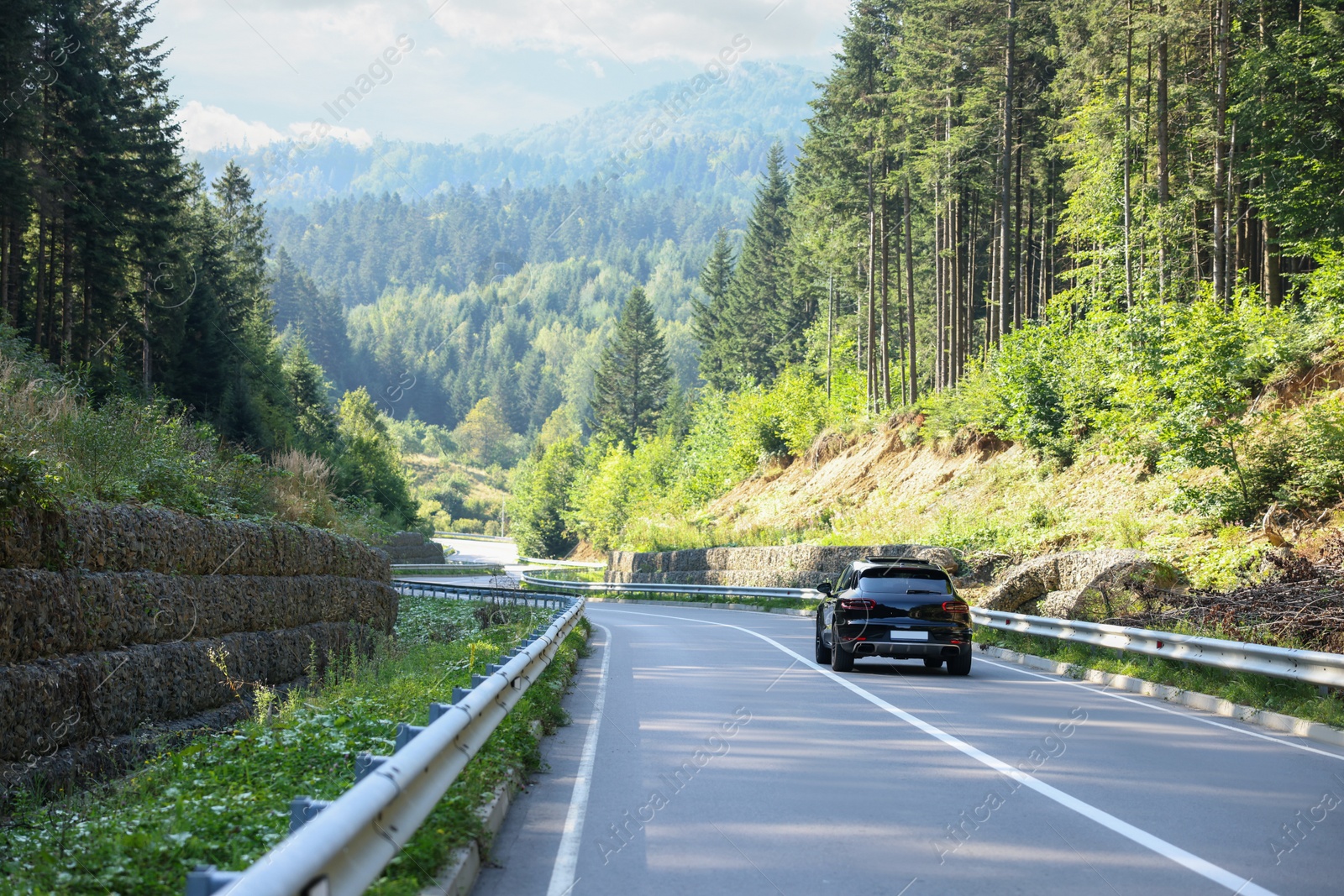 Photo of Picturesque view of asphalt road with modern car