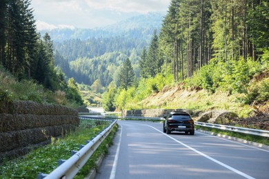 Photo of Picturesque view of asphalt road with modern car