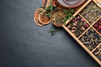 Flat lay composition with different dry teas and hot drink on black table. Space for text